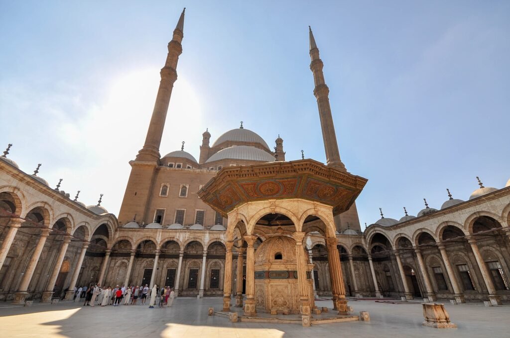 Mezquita de Alabastro de Muhammad Ali en la Ciudadela de El Cairo, Egipto, con sus dos finos minaretes, las cupulas grises y la fuente de ablucion en el patio