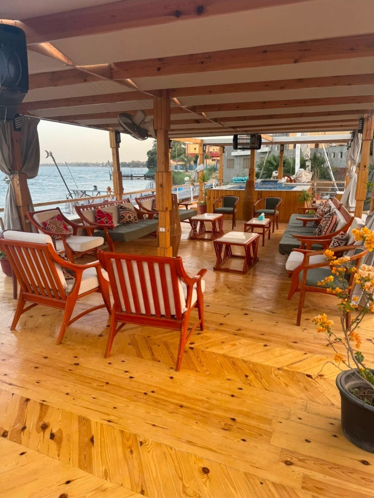 Wooden armchairs with striped cushions on the Akhenaton terrace