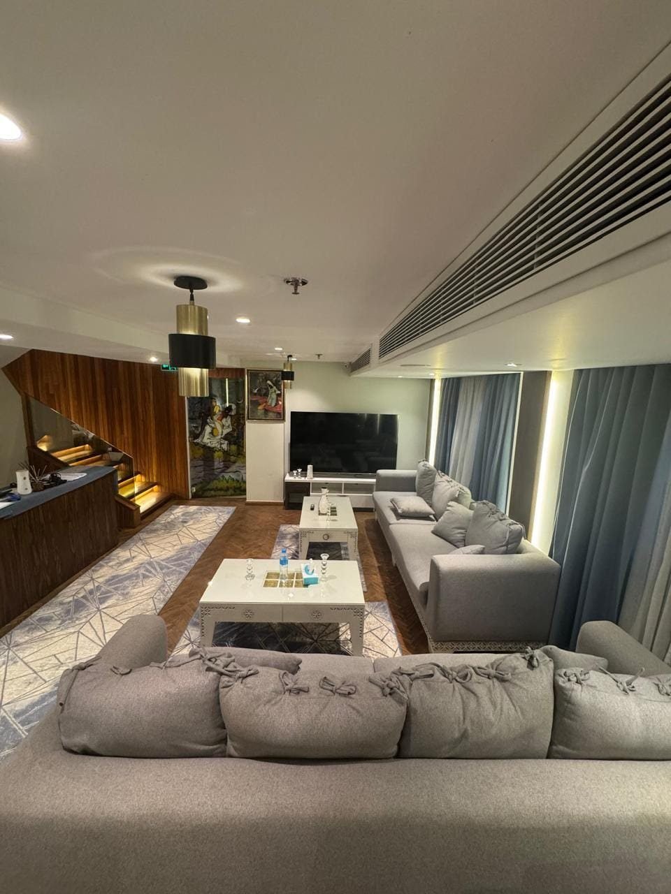 Indoor lounge on the Iris with grey sofas and river-facing windows
