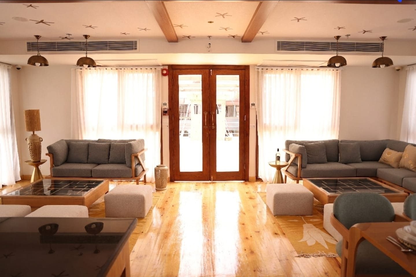Main lounge on the Per-ba with two sofa areas and glazed doors
