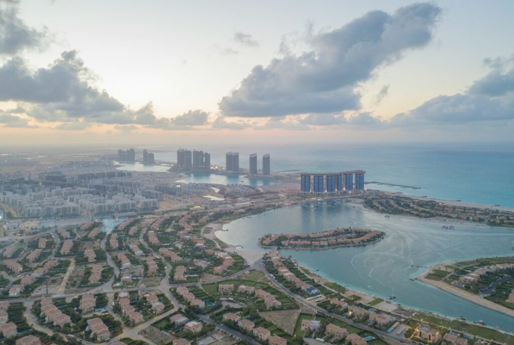 Aerial view of the El Alamein coast with the turquoise lagoon, villas and the towers of New Alamein on the Mediterranean