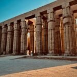 The papyrus-column colonnade of Luxor Temple under a deep blue sky