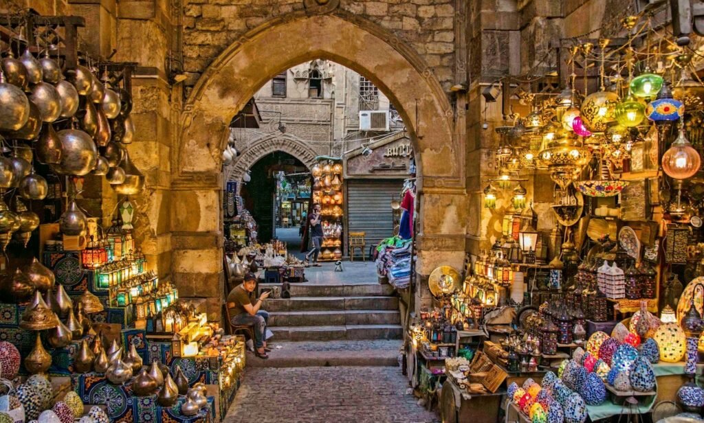 Un callejón del bazar de Khan el-Khalili, en El Cairo, lleno de faroles de colores bajo un arco de piedra