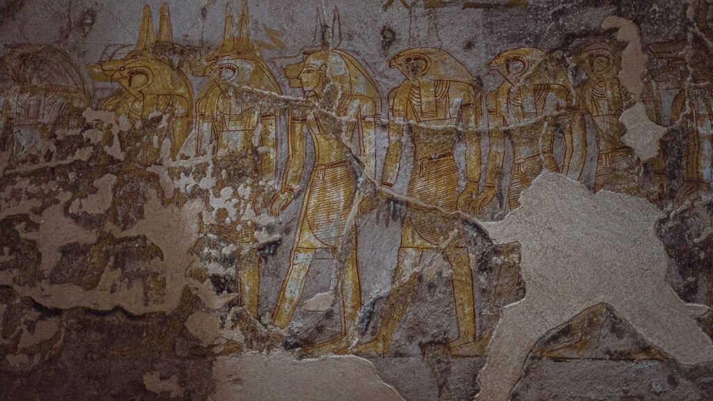 Figures of gods painted on the wall of an Egyptian tomb, the colour worn by time