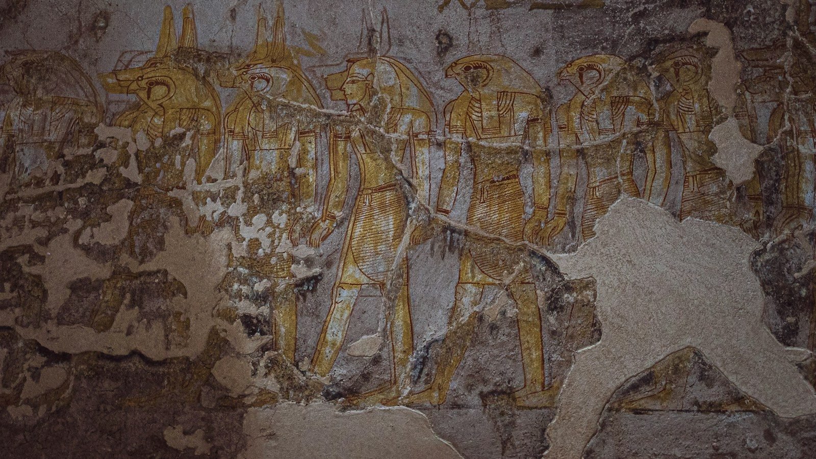 Figures of gods painted on the wall of an Egyptian tomb, the colour worn by time