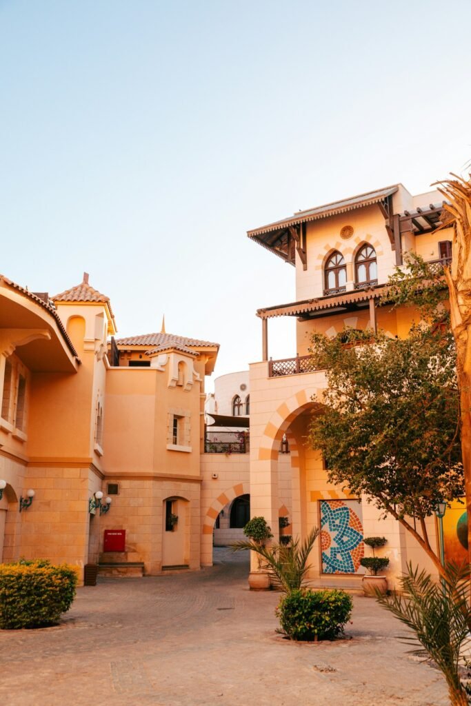 A street in the Sahl Hasheesh Old Town with ochre villas, arches and palms